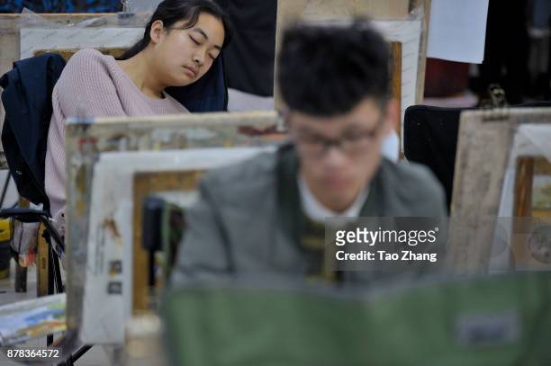 Girl sleeps at a training institute in Harbin, China's Heilongjiang province, on November 24 ,2017. Art colleges in China make their own tests for...