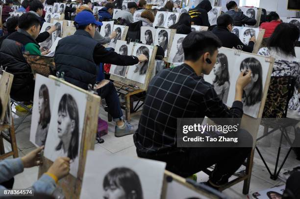 Senior high school students painting to major in art prepare for the upcoming college entrance exam at a training institute in Harbin, China's...