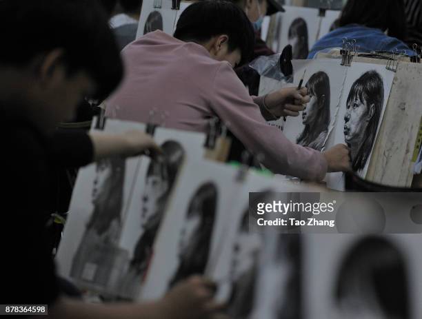 Senior high school students painting to major in art prepare for the upcoming college entrance exam at a training institute in Harbin, China's...