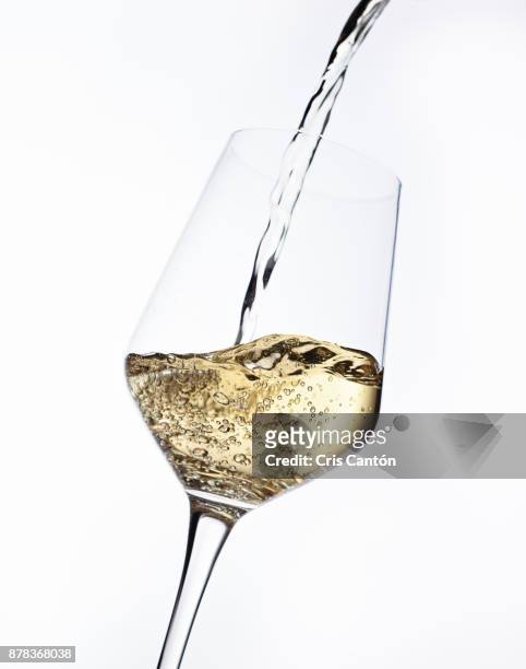 white wine pouring into glass - pouring stock pictures, royalty-free photos & images