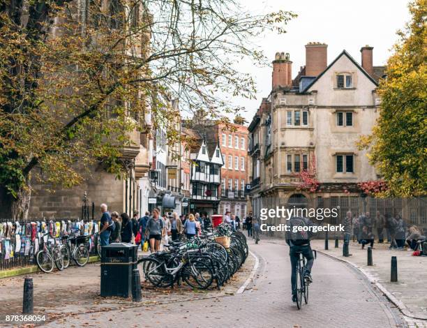 cyclist on a street in cambridge, england - cambridge england stock pictures, royalty-free photos & images