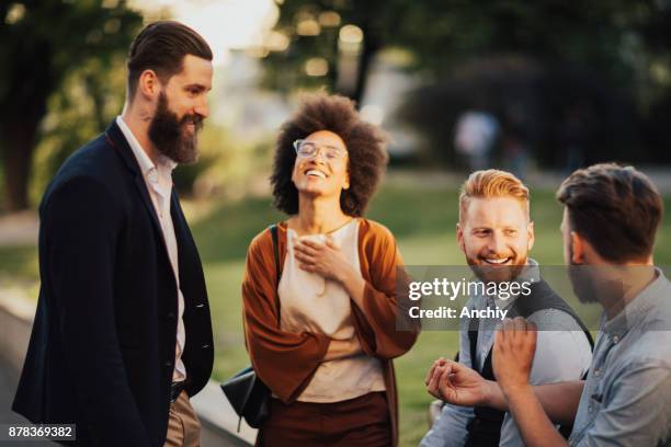 smiling business people outdoors in the street on coffee brake - afterwork stock pictures, royalty-free photos & images