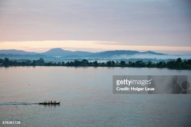 silhouette of boat on ayeyarwady (irrawaddy) river at dusk, shwegu, kachin, myanmar - kachin stock-fotos und bilder