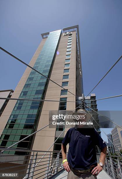 Player Briny Baird stands in front of the Omni Hotel after hitting off the roof of the Hotel attempting to land a golf ball on a bulls-eye planted in...