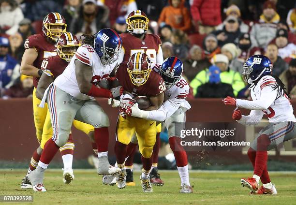 Washington Redskins running back Samaje Perine is trapped by New York Giants defensive tackle Damon Harrison and defensive end Jason Pierre-Paul...