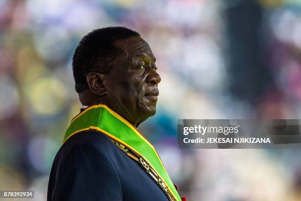 Zimbabwe's new interim President Emmerson Mnangagwa reviews the honour guard for the first time as president after being sworn-in during a ceremony...