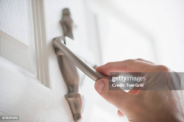 hand about to use a door knocker - bussare foto e immagini stock