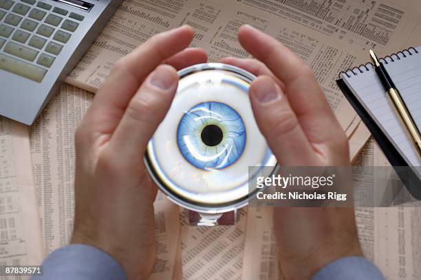 hands holding crystal ball - occhio di vetro foto e immagini stock