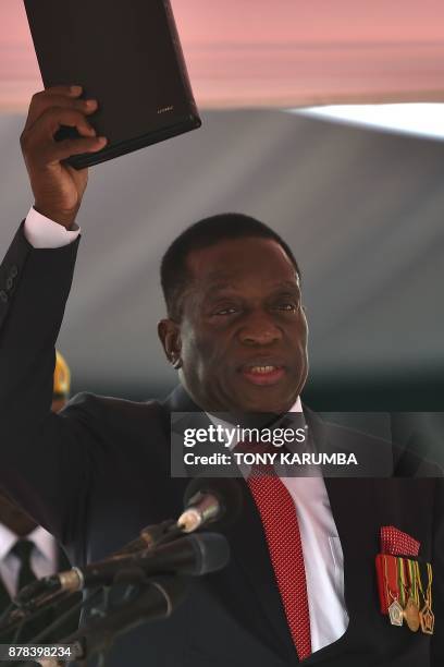 Zimbabwe's new interim President Emmerson Mnangagwa takes the oath of office before Chief judge of the Supreme Court as he is officially sworn-in...