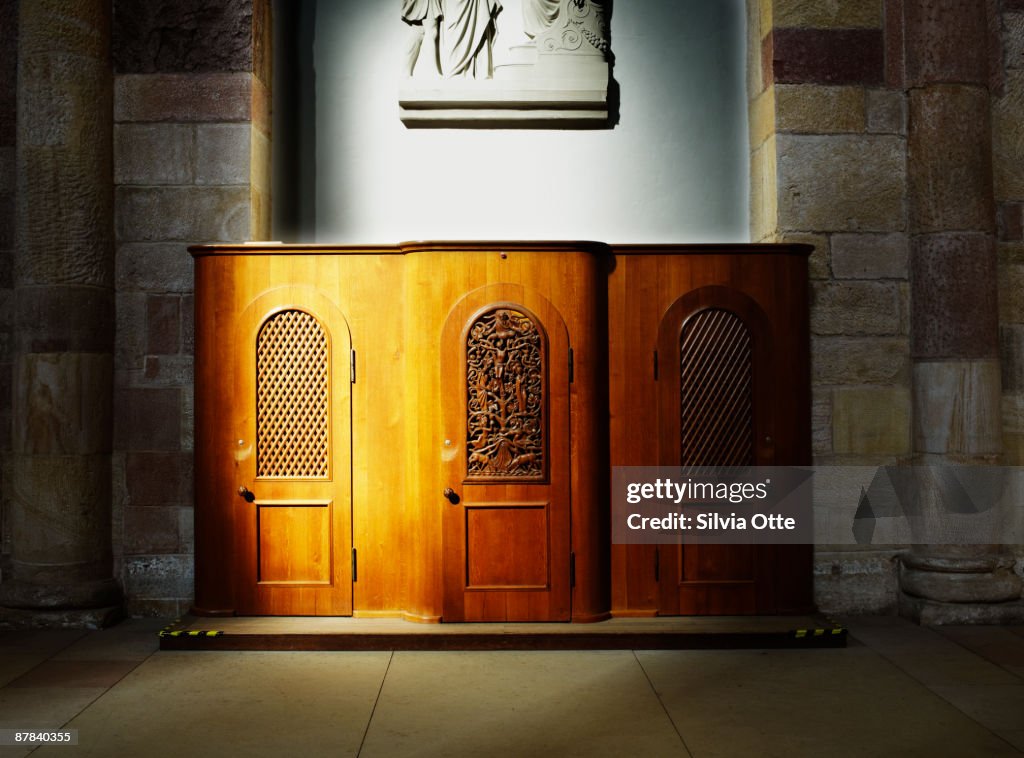 Confession booth illuminated by rays of the sun