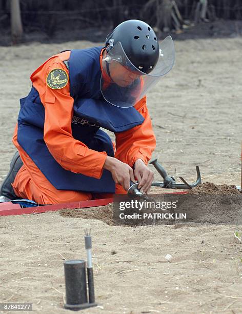 Taiwan-politics-China-Ma-anniversary by Benjamin Yeh A Taiwan army soldier wearing protective gear displays ways of clearing a landmine near the...