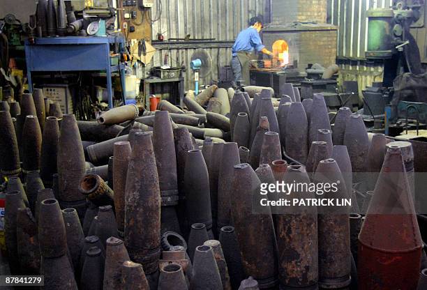 Taiwan-politics-China-Ma-anniversary by Benjamin Yeh The picture taken on May 18, 2009 shows artillery shells piled up at a knife shop on...