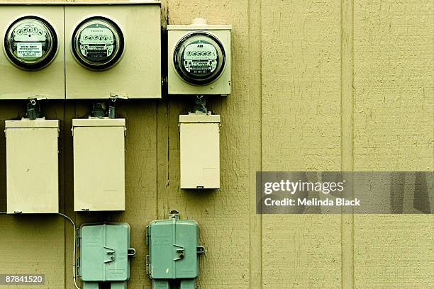 creepy utility meters on apartment building - ampèremètre photos et images de collection