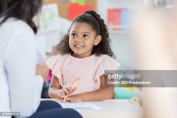 smiling preschooler talks with teacher - flash card stock pictures, royalty-free photos & images
