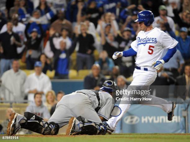 Mark Loretta of the Los Angeles Dodgers scores the winning run in front of Ramon Castro off of an Orlando Hudson at bat resulting in a fielder's...