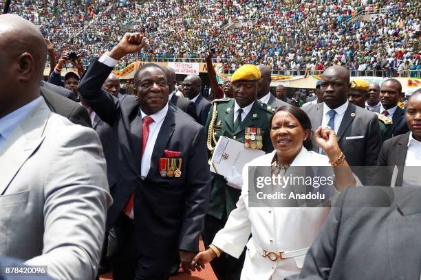 Emmerson Mnangagwa greets the crowd at the National Sports Stadium during his oath-taking ceremony following Robert Mugabes resignation in Harare,...