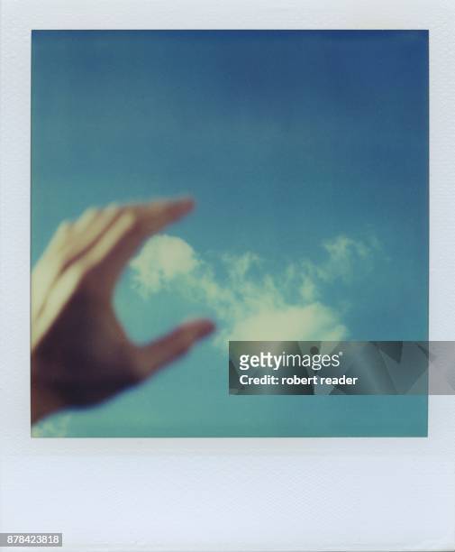 polaroid photograph of hand and clouds - truro cornwall stockfoto's en -beelden