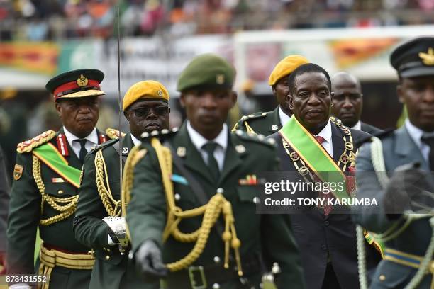 Zimbabwean new interim President Emmerson Mnangagwa performs his first inspection of the Guard of Honour accompanied by military chiefs after he is...