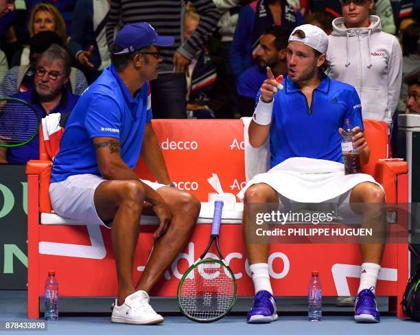 France's Lucas Pouille talks with captain Yannick Noah during the Davis Cup World Group singles rubber final tennis match between France and Belgium,...