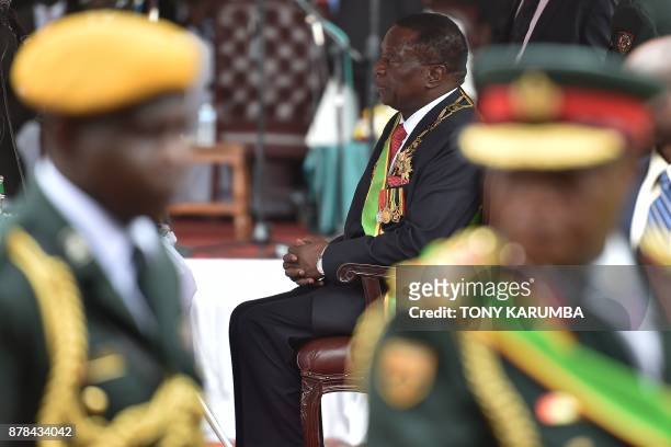 Zimbabwean new interim President Emmerson Mnangagwa sits after he was officially sworn-in during a ceremony in Harare on November 24, 2017. Emmerson...