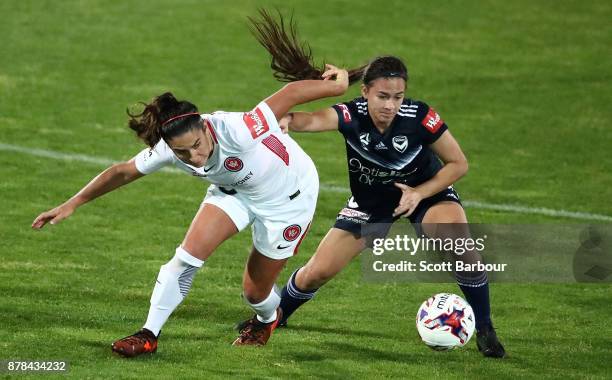 Angela Beard of the Victory and Lee Falkon of the Wanderers compete for the ball during the round eight W-League match between the Melbourne Victory...