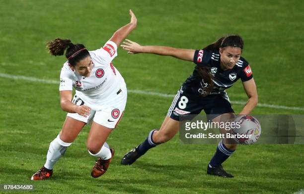 Angela Beard of the Victory and Lee Falkon of the Wanderers compete for the ball during the round eight W-League match between the Melbourne Victory...