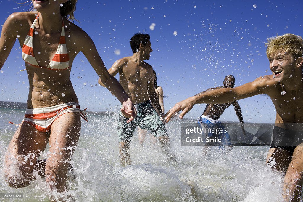 Friends chasing each other in the water