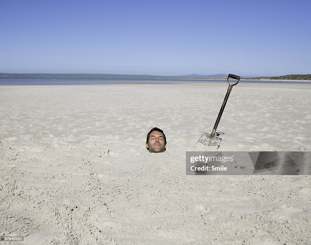 Man buried in the sand