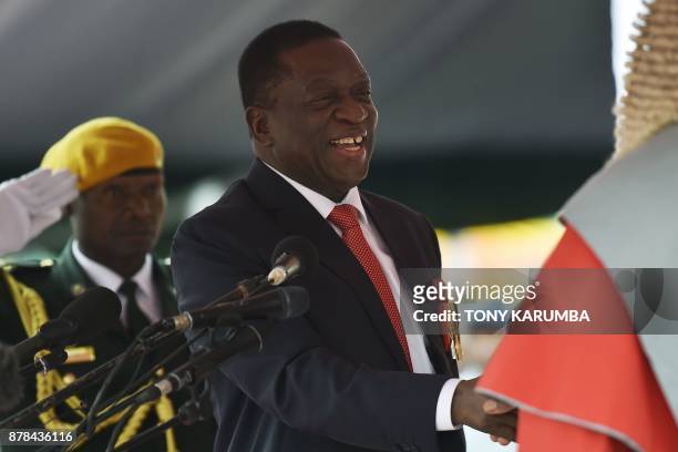 Zimbabwean new interim President Emmerson Mnangagwa shakes hands with Chief Justice of the Supreme Court, Luke Malaba after he is officially sworn-in...