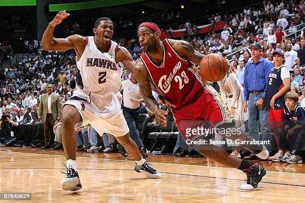 LeBron James of the Cleveland Cavaliers drives the ball against Joe Johnson of the Atlanta Hawks in Game Four of the Eastern Conference Semifinals...