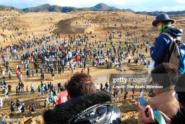 People enjoy Pokemon Go during the Pokemon GO Safari Zone at Tottori Sand Dune on November 24, 2017 in Tottori, Japan. For the first day of three-day...