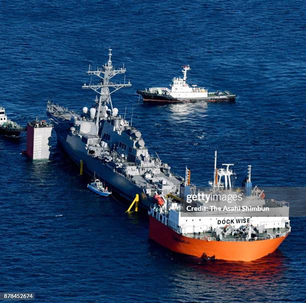 In this aerial image, the process to load damaged USS Fitzgerald on to Heavy Load Carrier Transshelf continues off Yokosuka on November 24, 2017 in...