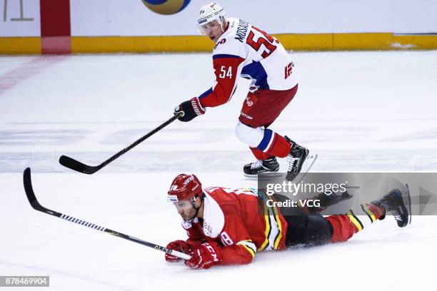 Brandon Yip of HC Kunlun Red Star and Denis Mosalyov of Lokomotiv Yaroslavl vie for the puck during the 2017/18 Kontinental Hockey League Regular...