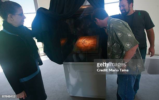 People view the 47 million year old fossilized remains of a primate is seen at the American Museum of Natural History May 19, 2009 in New York City....