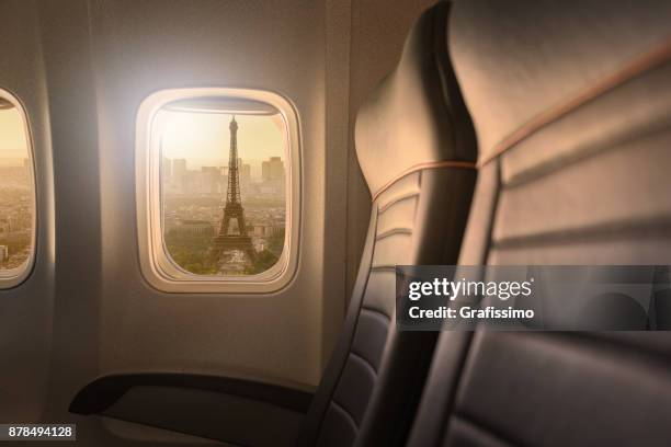 window of airplane with sight to eiffelturm in paris - eifelturm stock pictures, royalty-free photos & images