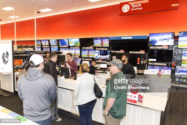 Shoppers wait in line to purchase electronics at a Target Corp. Store on Black Friday in Dallas, Texas, on Friday, Nov. 24, 2017. The National Retail...