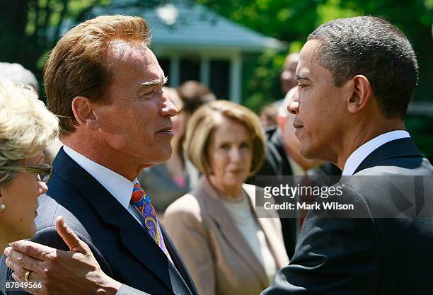 President Barack Obama greets California Gov. Arnold Schwarzenegger during a press conference announcing fuel efficiency standards in the Rose Garden...