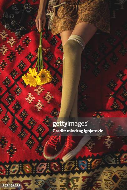 boho girl lying down on the carpet - girl lying down stock pictures, royalty-free photos & images