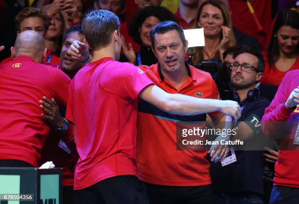 David Goffin of Belgium celebrates with his coach Thierry Van Cleemput winning the first match against Lucas Pouille of France during day 1 of the...