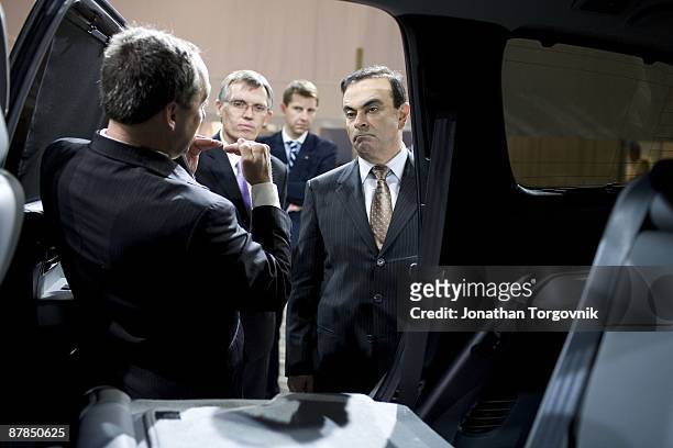 Carlos Ghosn, CEO of Nissan and Renault speaks with staff members at the Los Angeles auto show November 14, 2007 in Los Angeles, California.