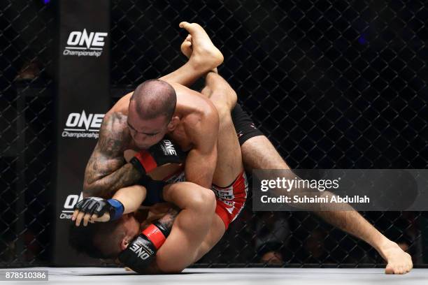 Leandro Issa of Brazil fights with Dae Hwan Kim of South Korea in the Bantamweight bout during ONE Championship: Immortal Pursuit at the Singapore...