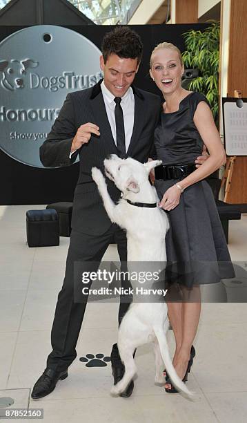 Actor Kevin Sacre and professional dancer Camilla Dallerup pose with Sven the dog during the Dogs Trust Honours 2009 at The Hurlingham Club on May...