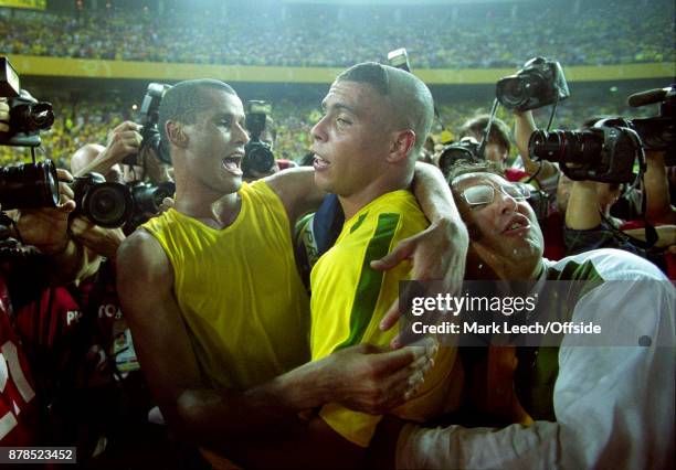 June 2002 Yokohama : FIFA World Cup Final - Brazil v Germany : a fan invades the post match Brazil celebration between Rivaldo and Ronaldo