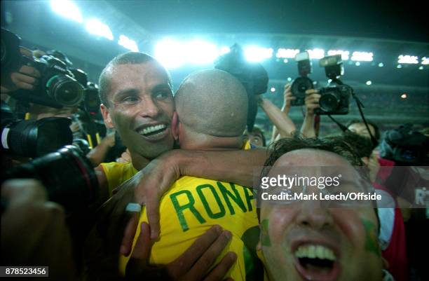 June 2002 Yokohama : FIFA World Cup Final - Brazil v Germany : a fan invades the post match Brazil celebration between Rivaldo and Ronaldo
