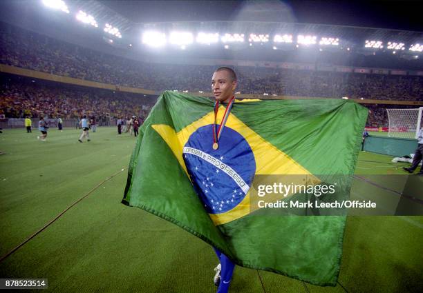 June 2002 Yokohama : FIFA World Cup Final - Brazil v Germany : Gilberto Silva of Brazil celebrates on a lap of honour, holding the Brazilian flag