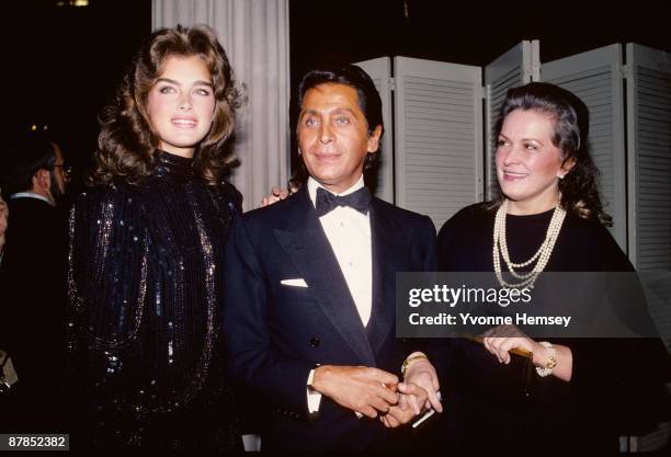 Brooke Shields and her mother, Teri Shields pose for a picture with designer Valentino during his Autumn/Winter fashion show at the Metropolitan...