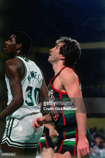 Ernie Grunfeld of the Milwaukee Bucks and Cedric Maxwell of the Boston Celtics look for a reboun during a game played in 1979 at the Boston Garden in...