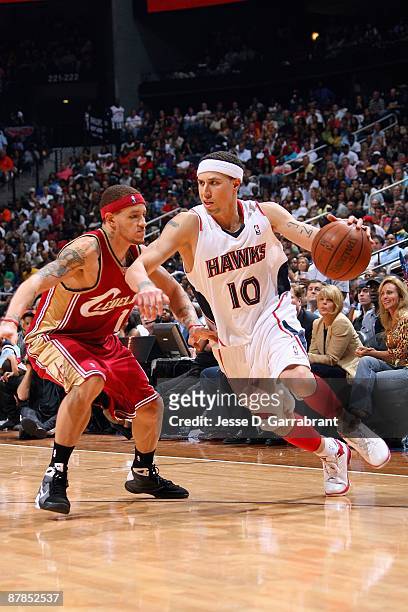 Mike Bibby of the Atlanta Hawks drives against Delonte West of the Cleveland Cavaliers in Game Three of the Eastern Conference Semifinals during the...