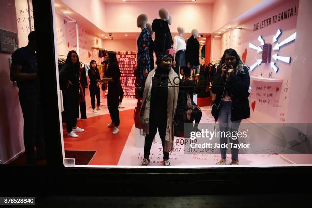Members of the public look on from inside a shop on Regent Street on November 24, 2017 in London, England. Police are responding to reports of an...