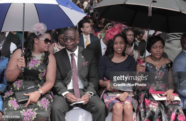 People react as Zimbabwean new President Emmerson Mnangagwa is officially sworn-in during a ceremony in Harare on November 24, 2017. Emmerson...